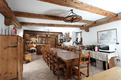 a dining room with a wooden table and chairs at Agritur al Canyon in Cloz