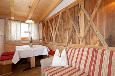 a living room with a couch and a table at Tiefentalhof - Urlaub am Bauernhof in Tesido