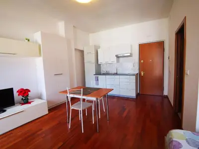 a kitchen with a table and chairs in a room at Apartment BELLA VISTA in Bolzano