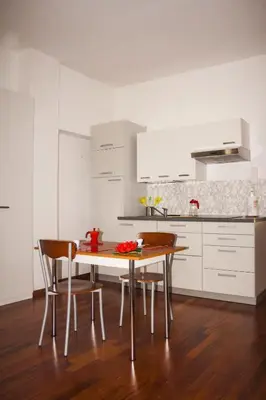 a kitchen with a table and chairs in a room at Apartment BELLA VISTA in Bolzano