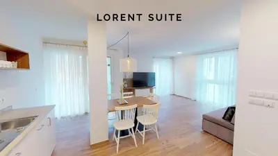 a kitchen and living room with a table and chairs at Lorent House in Merano