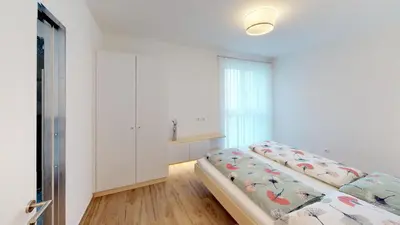 a bedroom with a bed and a window at Lorent House in Merano