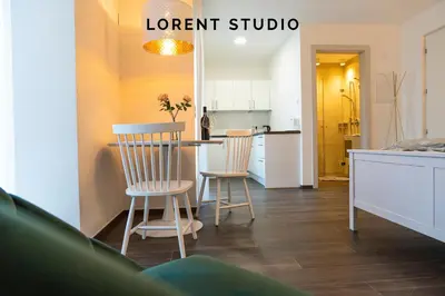 a kitchen with a table and two chairs in a room at Lorent House in Merano