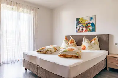 a bedroom with a large bed with pillows at Garni Wieterer in Terlano