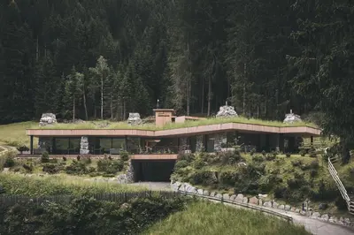 a house with a grass roof on top of it at Tenne Chalets in Racines