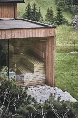 a building with a large window on the side of it at Tenne Chalets in Racines