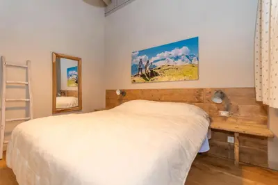 a bedroom with a bed and a mirror at Monte Pelmo in Alleghe