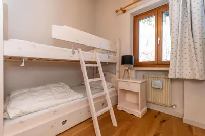 a bedroom with two bunk beds and a window at Monte Pelmo in Alleghe