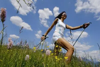 a woman is standing in a field of grass at Monte Pelmo in Alleghe