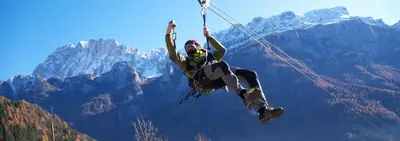 a man hanging from a rope in the mountains at Monte Pelmo in Alleghe