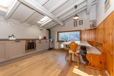 a kitchen with a table and chairs in it at Monte Pelmo in Alleghe