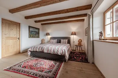 a bedroom with a bed with a rug and a window at Haus Sophie in Longomoso