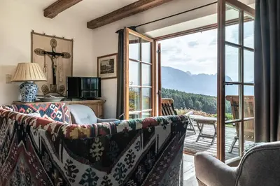 a living room with a couch and a sliding glass door at Haus Sophie in Longomoso