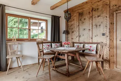a dining room with a wooden table and chairs at Haus Sophie in Longomoso