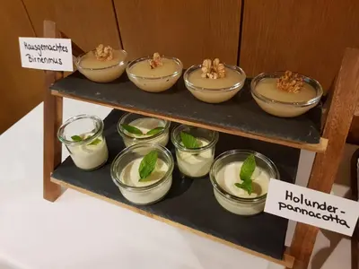 a shelf with bowls of food on a table at Pension Gartscheid in Lana