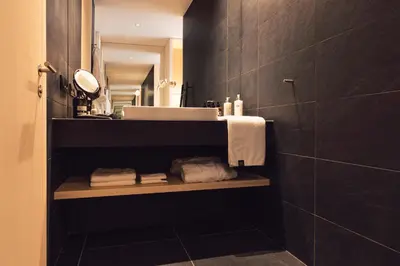 a bath tub in a bathroom with a balcony at Hotel Milla Montis in Maranza