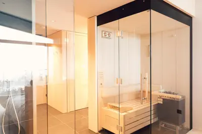 a glass shower stall in a room with at Hotel Milla Montis in Maranza