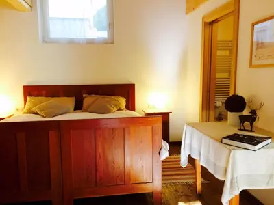 a bedroom with a bed and a table and a window at La terrazza gardenese in Santa Cristina in Val Gardena