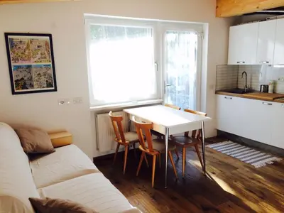 a kitchen with a table and chairs in a room at La terrazza gardenese in Santa Cristina in Val Gardena