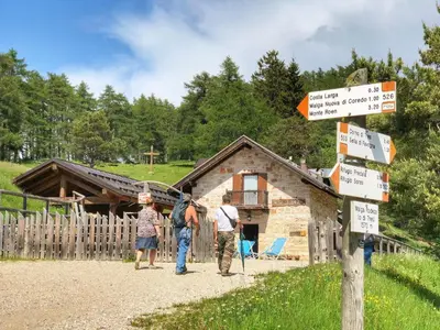 a group of people standing in front of a log cabin at Appartamento 