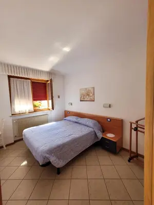 a small bedroom with a bed and a window at Appartamento 