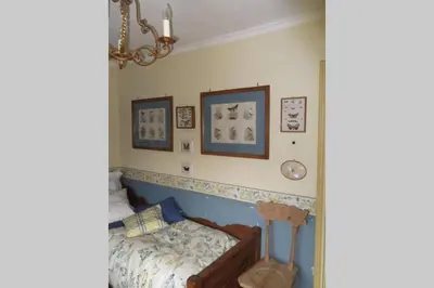 a bedroom with a bed and pictures on the wall at Paola’s Country Home - Vanoi Primiero Trentino in Canale San Bovo