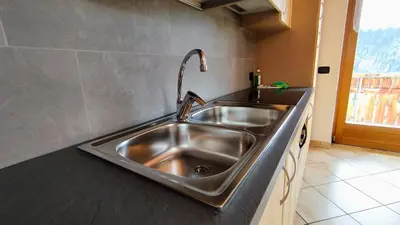 a stainless steel kitchen sink with a faucet at La Majon in Colle Santa Lucia