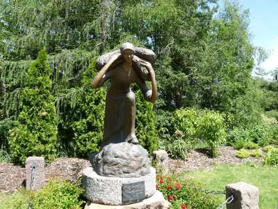 a statue of a woman holding an umbrella at Albergo Dolomiti in Capriana