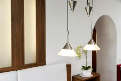 two lights hanging above a couch in a room at Col Dala Vara in San Cassiano