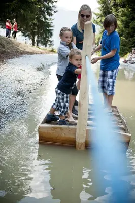 a group of children playing with a paddle in the water at Hotel Schölzhorn Superior in Racines