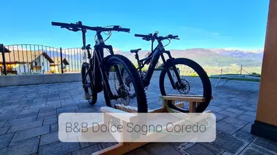 two bikes parked on a bike rack on a building at Affittacamere Dolce Sogno in Coredo