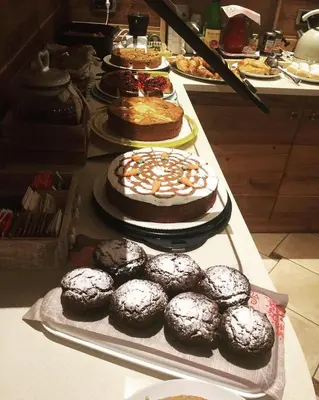 a bunch of cakes and cupcakes on a table at Affittacamere Dolce Sogno in Coredo