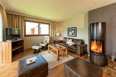 a living room with a fireplace and a couch at Weingut Eichenstein in Merano