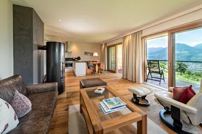 a living room with a couch and a table at Weingut Eichenstein in Merano