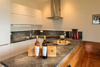 a kitchen with two bottles of wine on a counter at Weingut Eichenstein in Merano