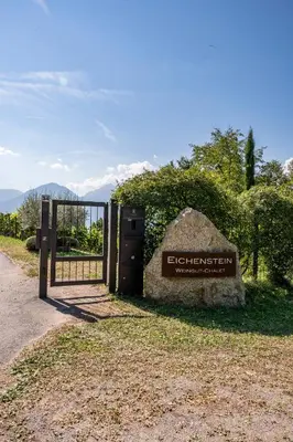 a gate with a sign in front of a fence at Weingut Eichenstein in Merano