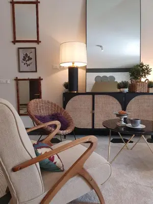 a living room with two chairs and a table at THE MIRROR GUESTHOUSE - TERME MERANO in Merano