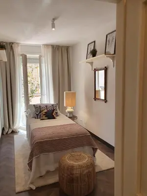 a bedroom with a bed and a window at THE MIRROR GUESTHOUSE - TERME MERANO in Merano