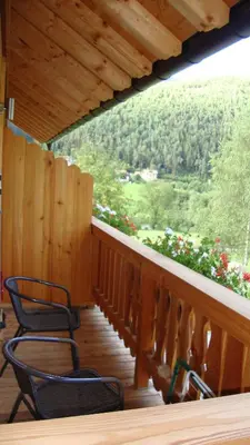 a porch with chairs and a view of a mountain at Winnewieser in Vandoies