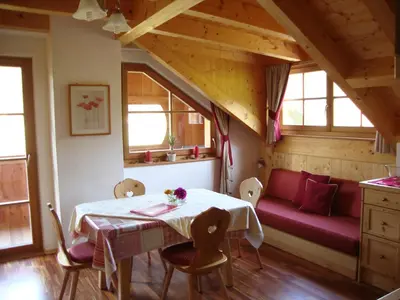 a dining room with a table and a couch at Winnewieser in Vandoies