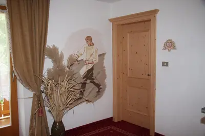 a painting of a man on a wall next to a door at Mair am Hof - Farm - Maso - Bauernhof in San Lorenzo di Sebato