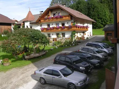 a group of cars parked in front of a house at Mair am Hof - Farm - Maso - Bauernhof in San Lorenzo di Sebato