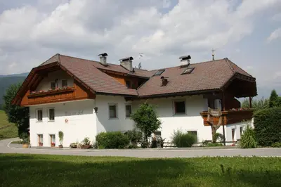 a large white house with a brown roof at Mair am Hof - Farm - Maso - Bauernhof in San Lorenzo di Sebato
