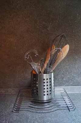 a metal container filled with utensils on a counter at Agritur Zuveith in Salorno sulla Strada del Vino