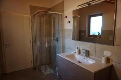 a bathroom with a shower and a sink and a mirror at Agritur Zuveith in Salorno sulla Strada del Vino