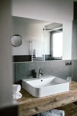 a bathroom with a white sink and a mirror at Schloss Auer in Tirolo