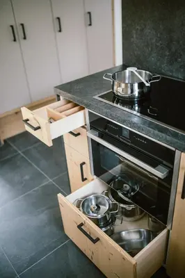 a kitchen with a stove with a pot on top at Schloss Auer in Tirolo