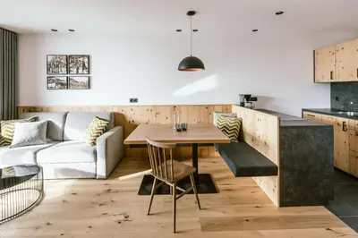a kitchen and living room with a table and a couch at Schloss Auer in Tirolo
