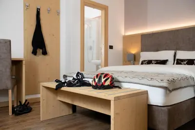 a living room with a couch and a bed at GARNI' Margherita in Predazzo