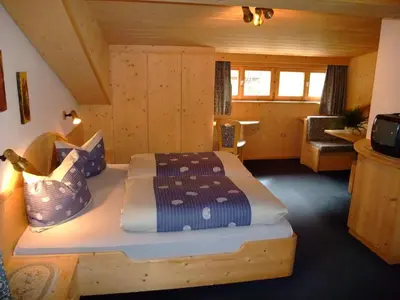 a bedroom with a bed in a log cabin at Garnì Conturina in Santa Cristina in Val Gardena